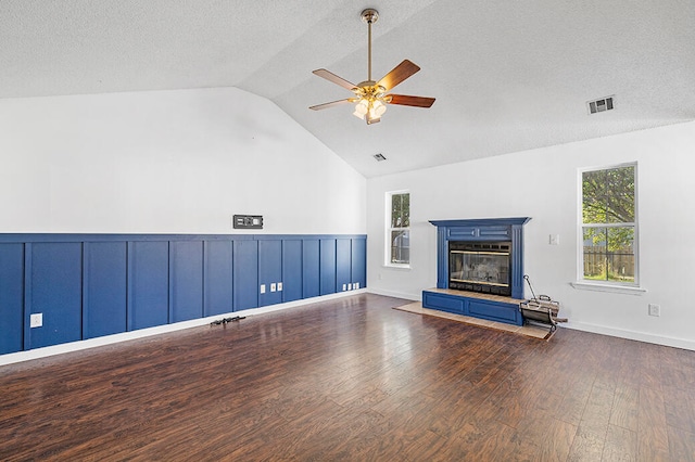 unfurnished living room with lofted ceiling, ceiling fan, a textured ceiling, and dark hardwood / wood-style flooring