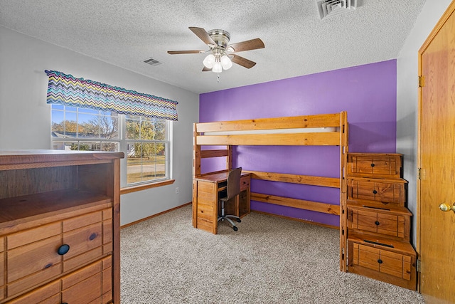 carpeted bedroom featuring a textured ceiling and ceiling fan