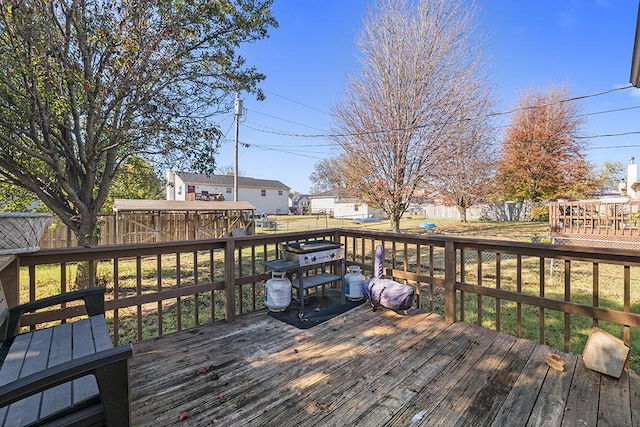 wooden deck featuring a yard