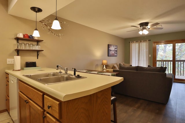 kitchen featuring decorative light fixtures, white dishwasher, dark hardwood / wood-style flooring, sink, and ceiling fan