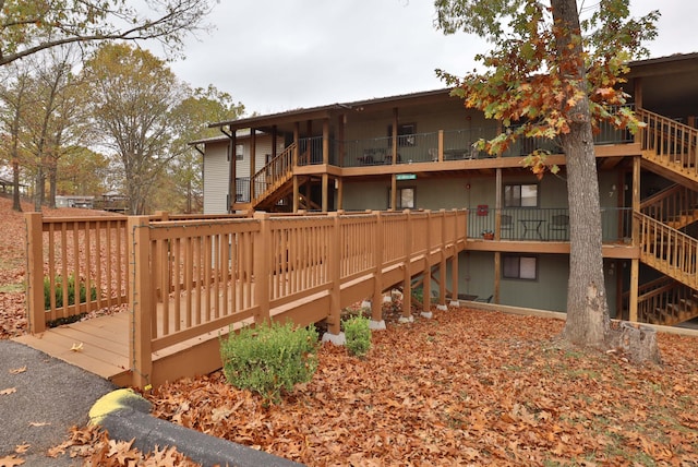 rear view of house featuring a wooden deck