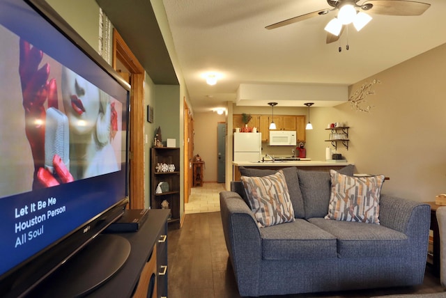 home theater featuring dark hardwood / wood-style flooring and ceiling fan