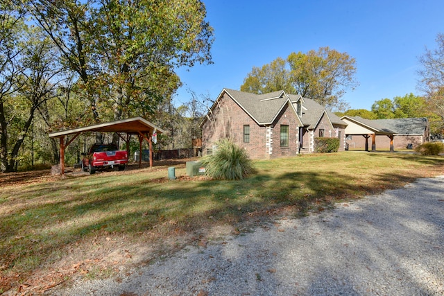 view of side of property featuring a garage, a lawn, and a carport