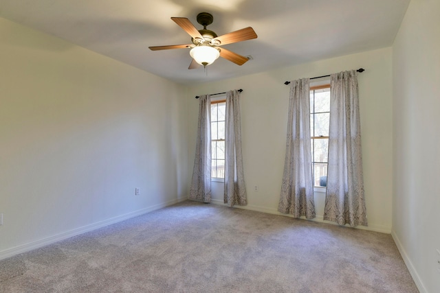 unfurnished room featuring light colored carpet and ceiling fan