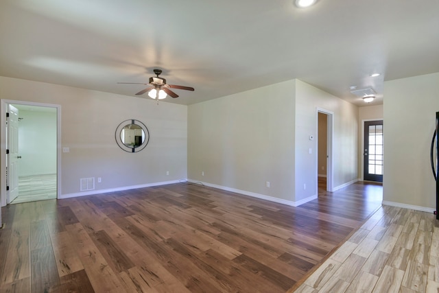 empty room featuring wood-type flooring and ceiling fan