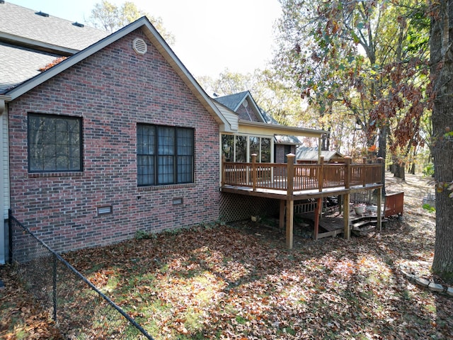 rear view of property featuring a deck