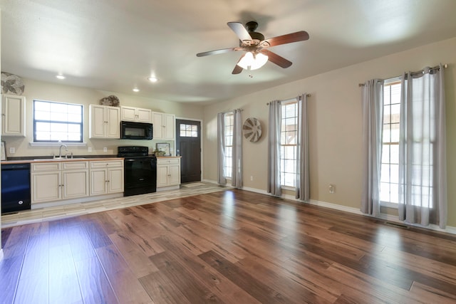 kitchen featuring black appliances, white cabinetry, ceiling fan, and light hardwood / wood-style floors