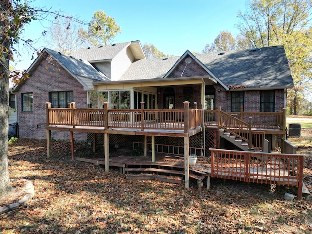 rear view of house featuring a wooden deck