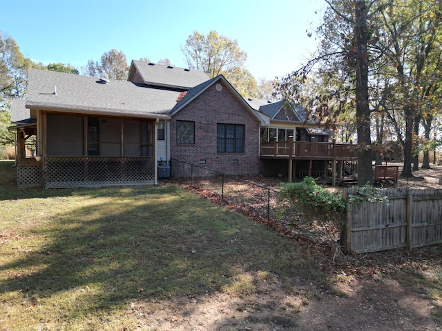 back of property with central AC unit, a lawn, and a wooden deck