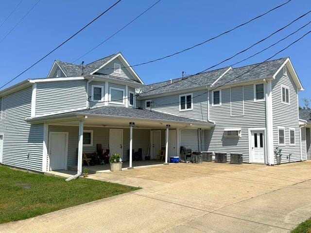 rear view of house featuring a yard