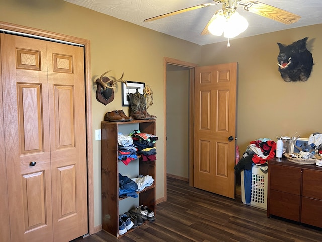 bedroom featuring ceiling fan, a textured ceiling, a closet, and dark hardwood / wood-style flooring