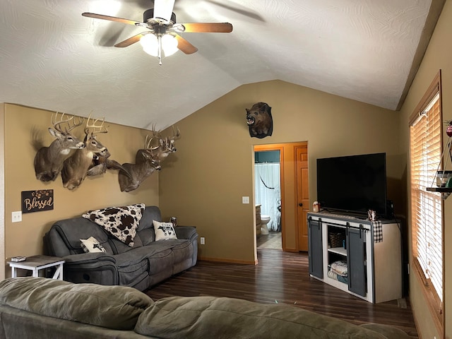 living room featuring ceiling fan, vaulted ceiling, and dark hardwood / wood-style floors