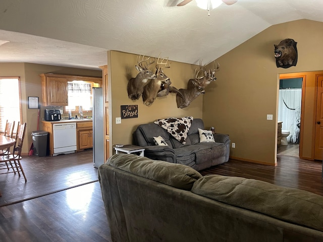 living room featuring dark hardwood / wood-style flooring, sink, vaulted ceiling, and ceiling fan