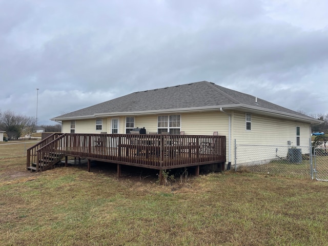 back of house with a yard and a deck