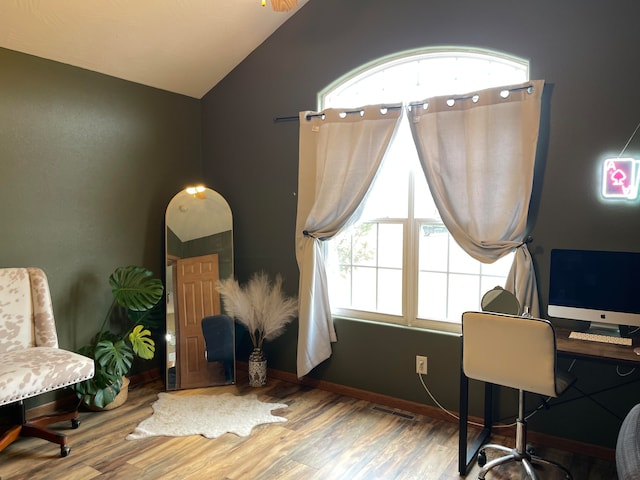 home office featuring wood-type flooring and vaulted ceiling