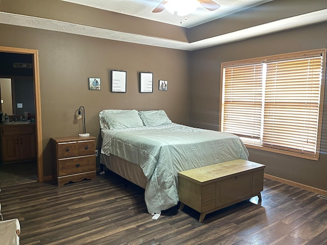 bedroom with ensuite bathroom, ceiling fan, and dark hardwood / wood-style flooring