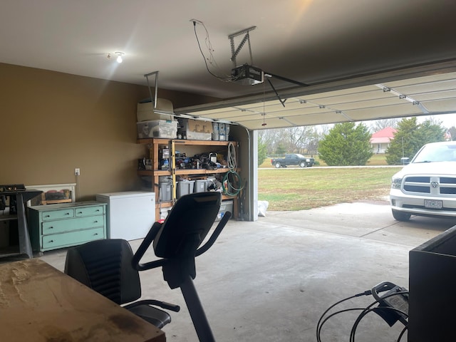 garage featuring a garage door opener, a yard, and white refrigerator