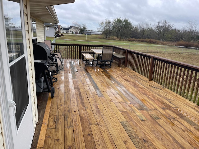 wooden deck with a lawn