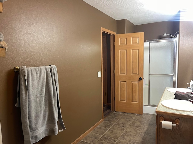 bathroom featuring walk in shower and vanity