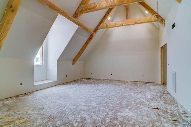 bonus room with beam ceiling and high vaulted ceiling