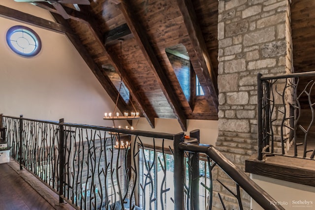 corridor with a chandelier, beamed ceiling, wood ceiling, and hardwood / wood-style flooring