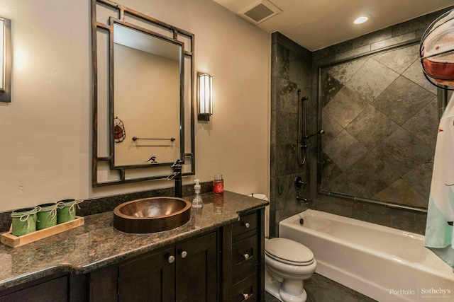 full bathroom featuring vanity, toilet, and tiled shower / bath