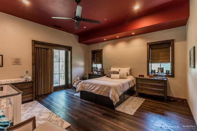 bedroom with dark hardwood / wood-style flooring and ceiling fan