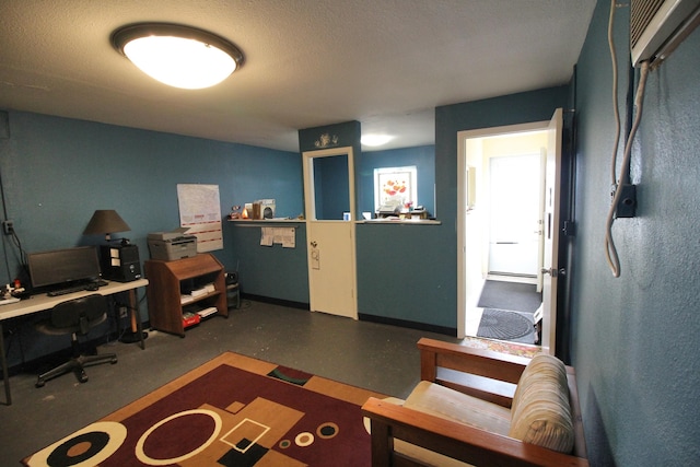 office area with a textured ceiling and a wall mounted air conditioner