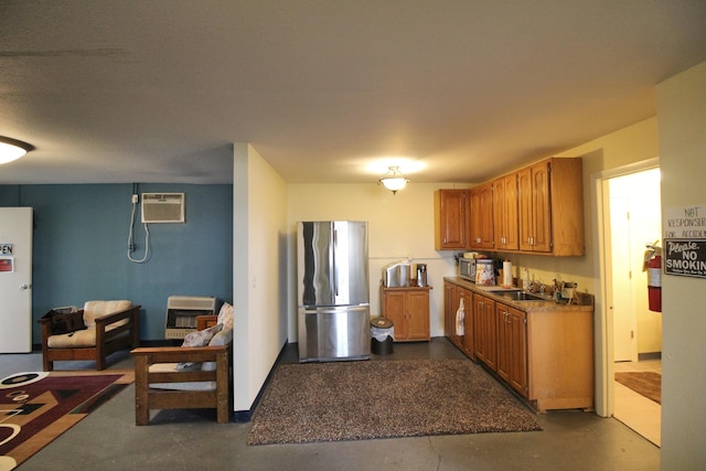 kitchen featuring a wall mounted AC, appliances with stainless steel finishes, and sink