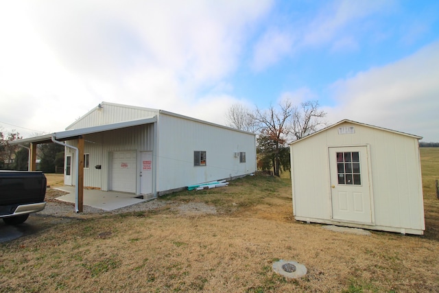 exterior space featuring a lawn and a storage unit