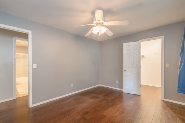 unfurnished room with ceiling fan and dark hardwood / wood-style floors