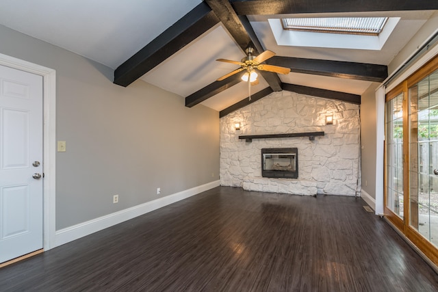 unfurnished living room with vaulted ceiling with skylight, ceiling fan, dark hardwood / wood-style floors, and plenty of natural light