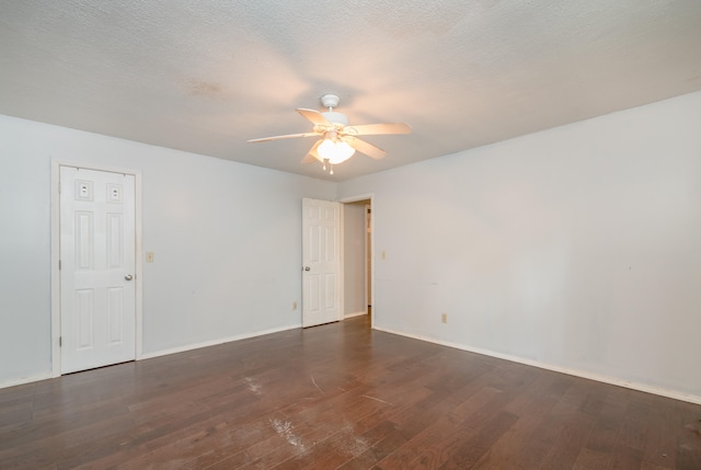 unfurnished room featuring a textured ceiling, dark hardwood / wood-style floors, and ceiling fan