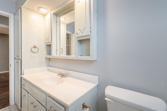 bathroom with hardwood / wood-style floors, vanity, and toilet