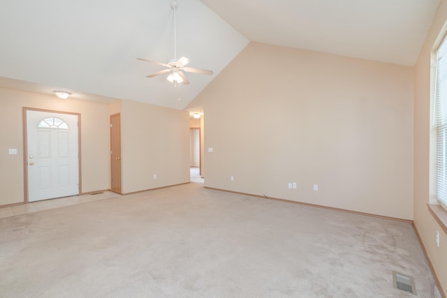 unfurnished living room featuring high vaulted ceiling, light carpet, and ceiling fan