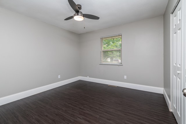 unfurnished room featuring ceiling fan and dark hardwood / wood-style flooring