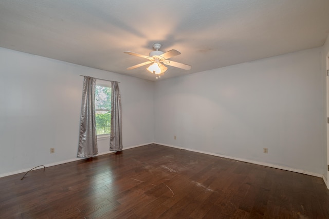 empty room featuring ceiling fan and dark hardwood / wood-style flooring