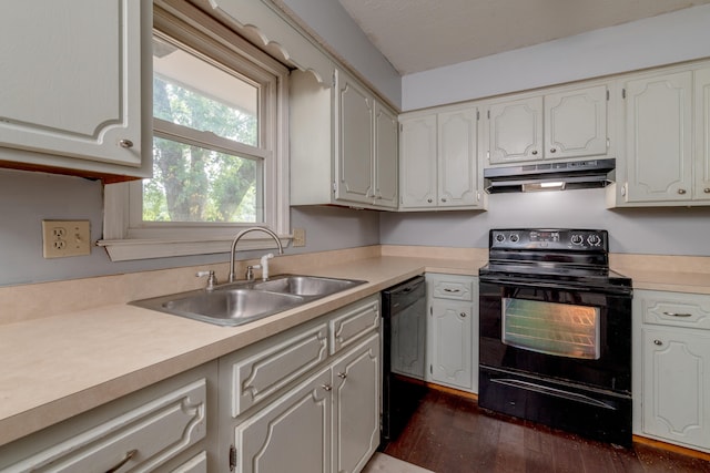 kitchen with black appliances, dark wood-type flooring, sink, and white cabinets