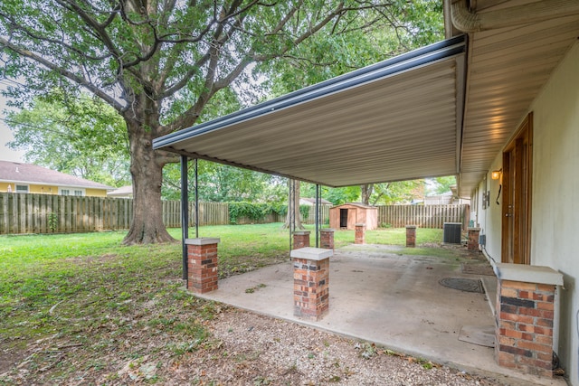 view of patio with cooling unit and a shed