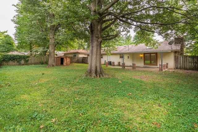 view of yard featuring a shed and a patio