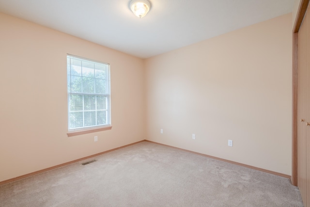 empty room featuring light carpet