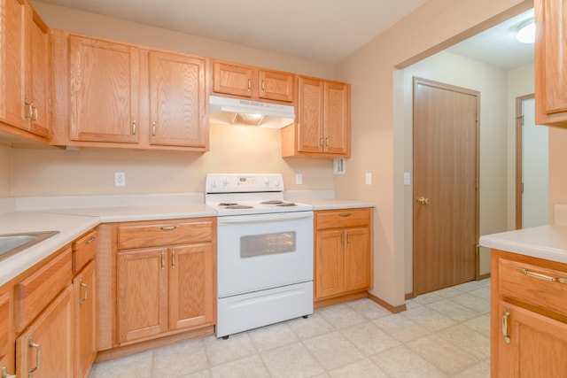 kitchen with light brown cabinets and white electric range oven