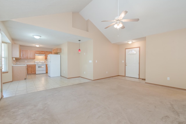 unfurnished living room with high vaulted ceiling, light carpet, and ceiling fan