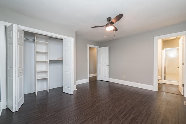 unfurnished bedroom with connected bathroom, dark hardwood / wood-style floors, ceiling fan, and a closet