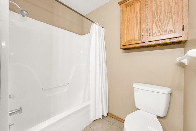 bathroom featuring tile patterned flooring, shower / bath combination with curtain, and toilet