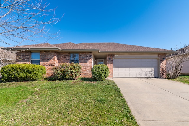 ranch-style house featuring a front lawn and a garage