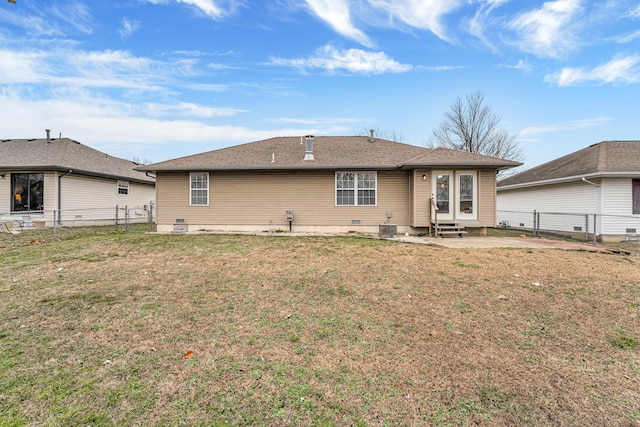 back of house featuring a lawn and a patio area