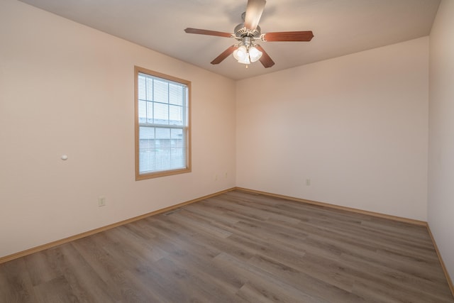 spare room featuring hardwood / wood-style flooring and ceiling fan