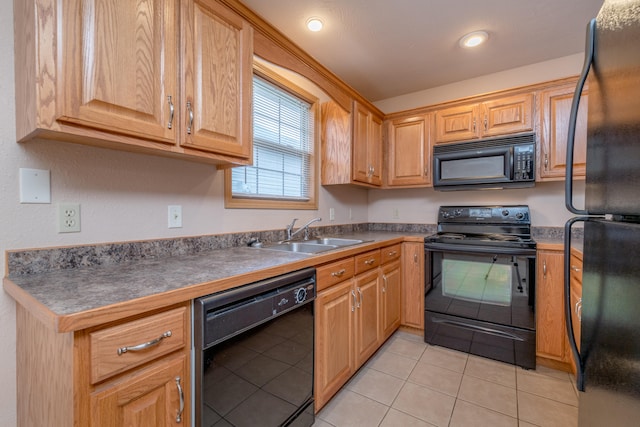 kitchen with black appliances, sink, and light tile patterned floors