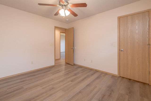 spare room with ceiling fan and light hardwood / wood-style flooring